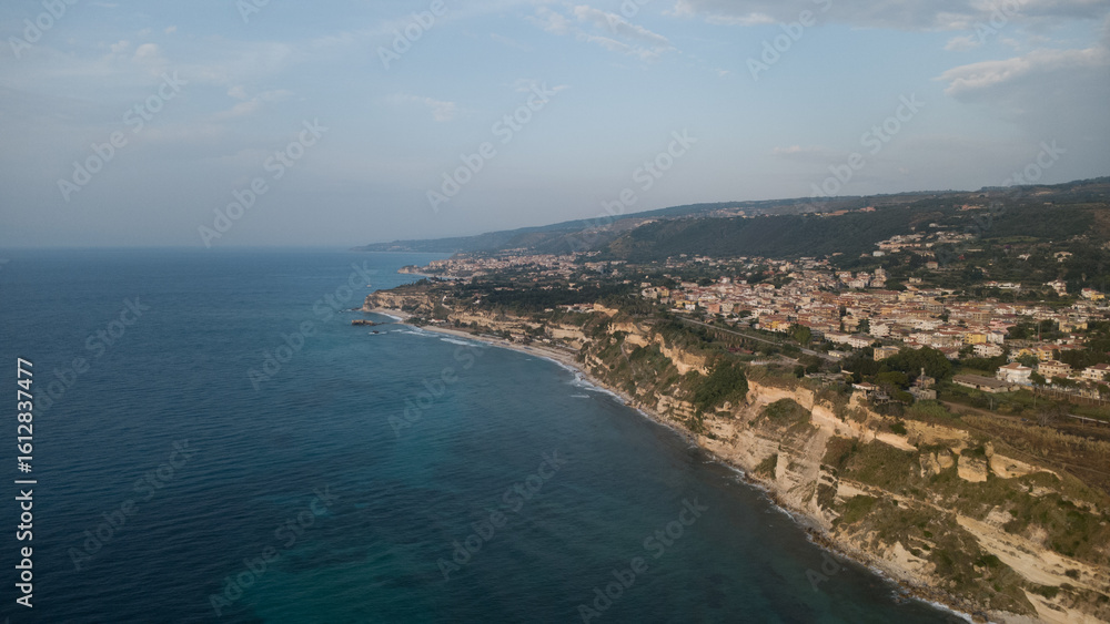 Coastal Town with Cliffside Architecture and Turquoise Sea – Aerial View, Southern Italy Coastal Town with Cliffside Architecture and Turquoise Sea – Aerial View, Southern Italy
