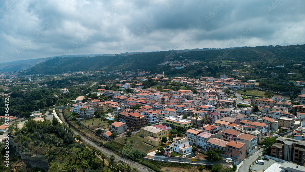 Naklejka premium Hilltop Town Near Tropea with Red Roofs and Railway – Aerial View