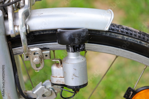 Photos A close-up of a bicycle's front wheel showcases the dynamo and braking system, highlighting technical details