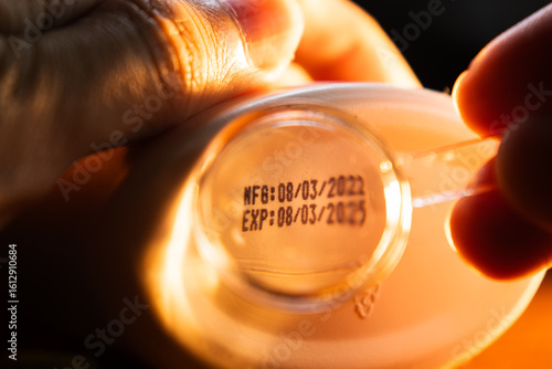 Reading Small Text of Manufacturing date and Expiration date on Bottom of Product with Magnifying Glass