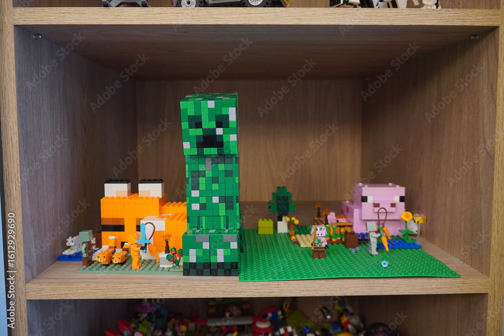 Naklejka premium Lego Minecraft Figures and Landscape on a Wooden Shelf