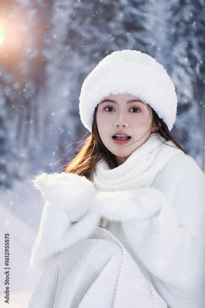 Young woman in winter attire enjoying snowfall outdoors.