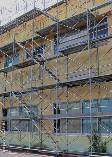 Wallpaper Mural A scaffolding surrounding the building that is being demolished. Torontodigital.ca