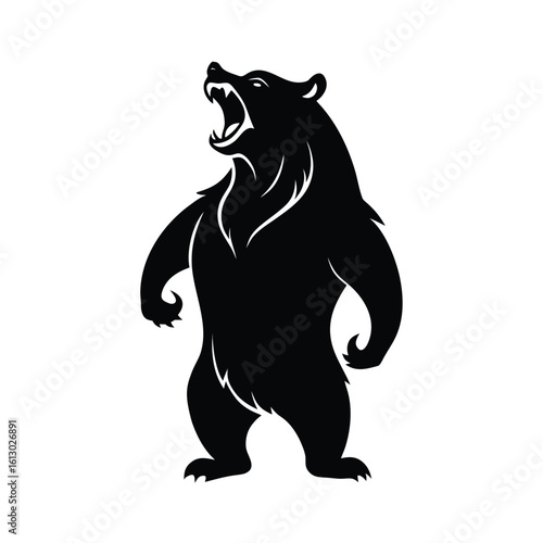 Powerful black silhouette of a bear standing on hind legs roaring fiercely