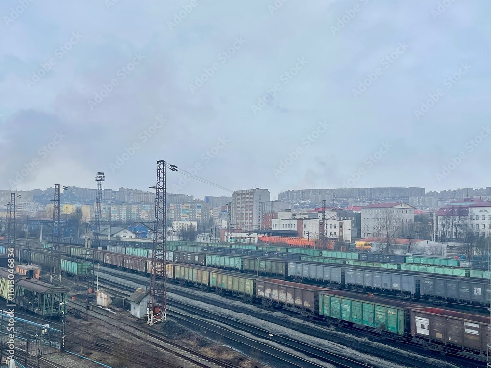 Fototapeta premium The railway station, freight trains in a cloudy spring day, Murmansk, Russia