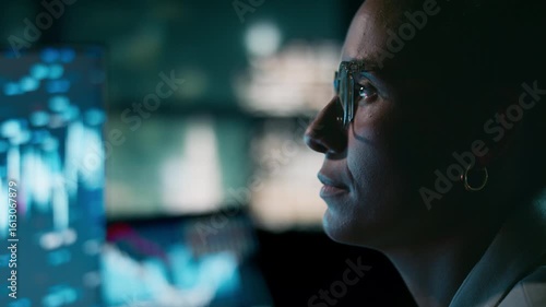 Close-up of businesswoman analysing stock market data in skyline office at night