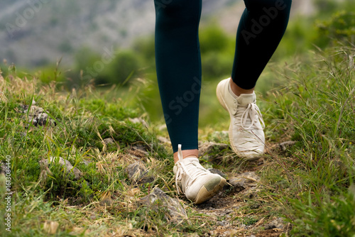 Obraz na plátně Woman spraining ankle while running outdoors, wear outfit leggings and white sne