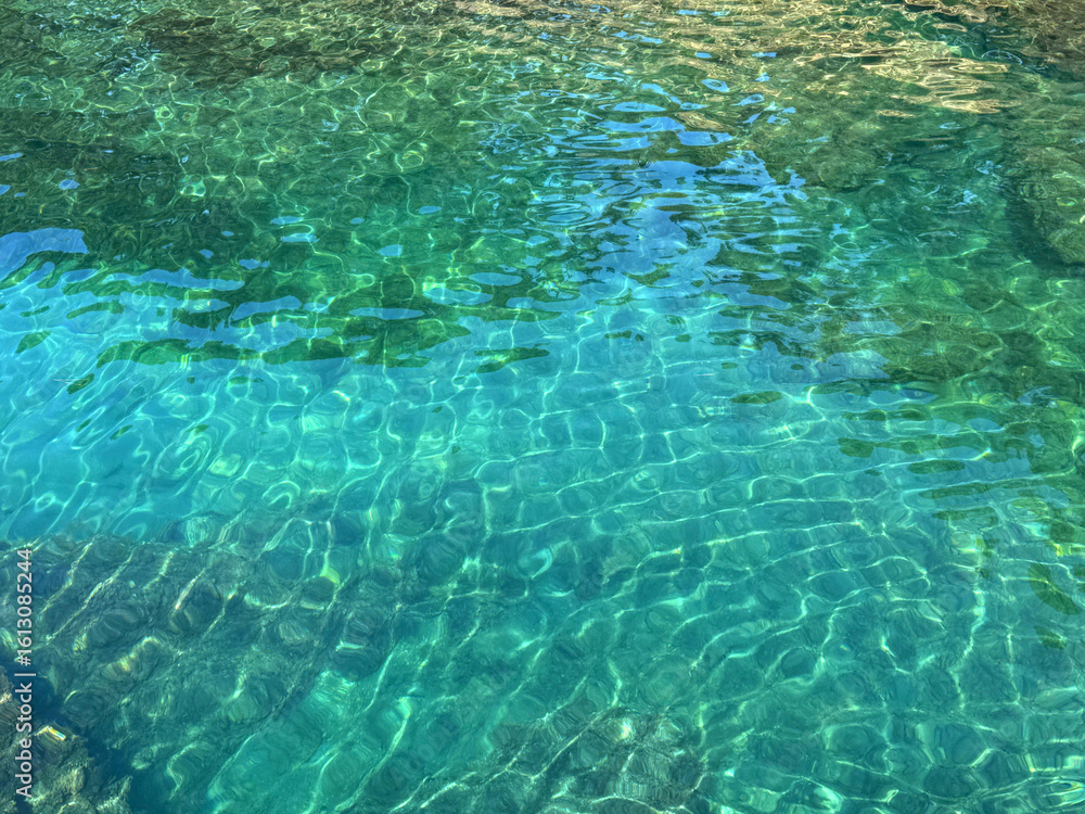 Naklejka premium Emerald green crystal clear sea water surface.