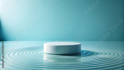 A white cylindrical pedestal sits in tranquil blue water with gentle ripples