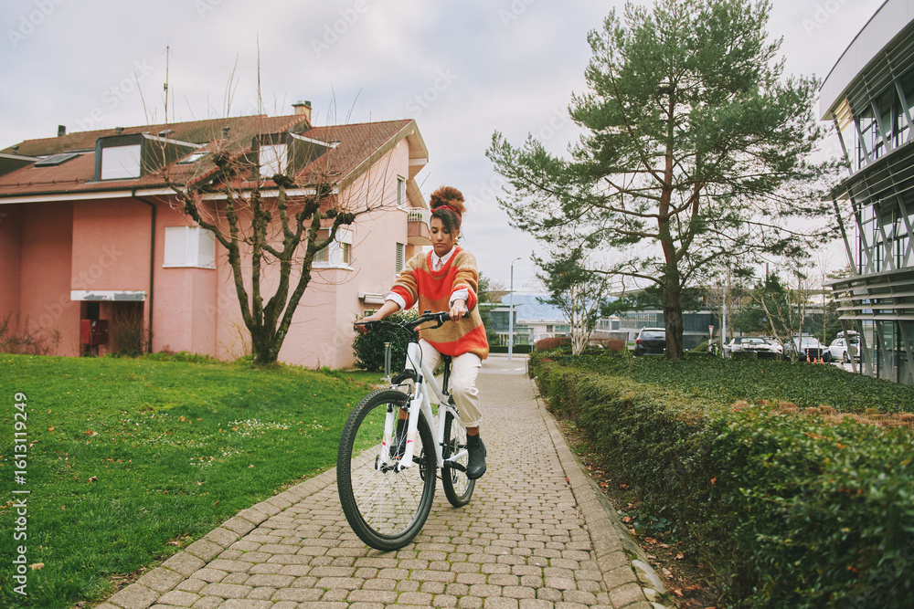 Fototapeta premium Portrait of african woman riding bike outdoors