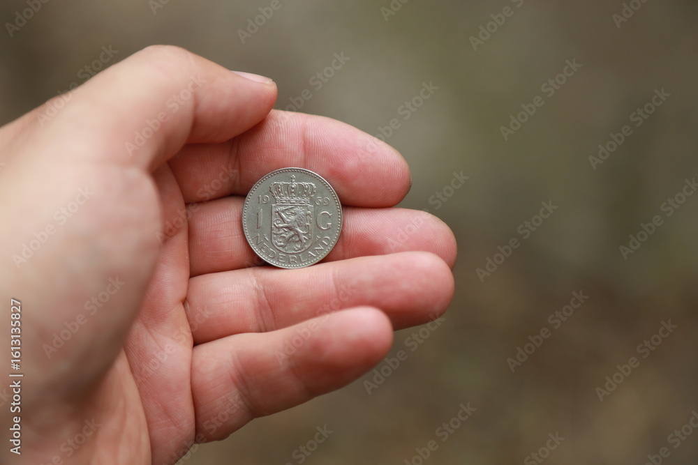Hand holding few small Dutch coin Hand holding few small Dutch coin