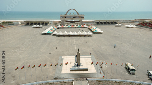 Aerial view of the expansive Black Star Square, framed by the serene ocean and fluttering Ghanaian flags, a scene of national pride, Osu Klottey, Greater Accra Region, Ghana.