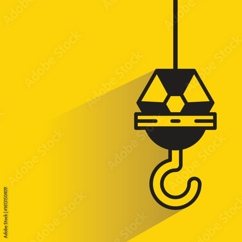 hoist crane hook icon with drop shadow on yellow background
