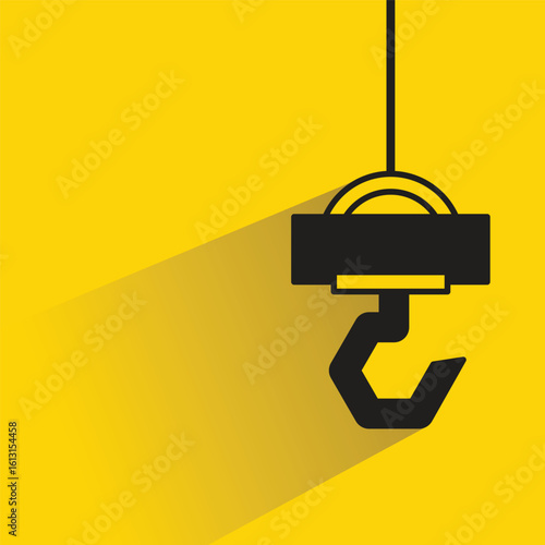 hoist crane hook icon with drop shadow on yellow background