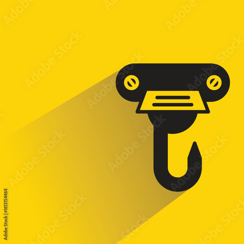 hoist crane hook icon with drop shadow on yellow background