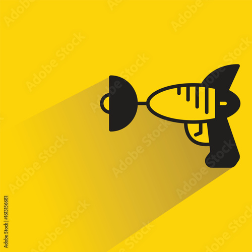 space gun with shadow on yellow background