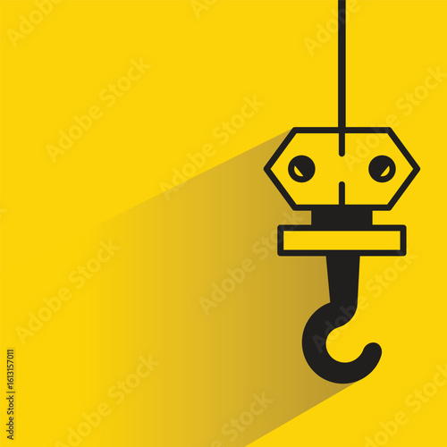 pulley crane hook icon with drop shadow on yellow background
