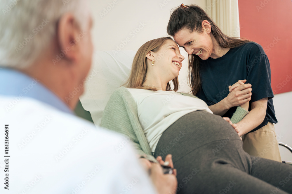 Fotografie Intimate moment between a lesbian couple during a pregnancy exam, touching foreheads with love and support