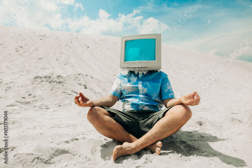 Person meditating on sand dune with CRT monitor head as computer metaphor