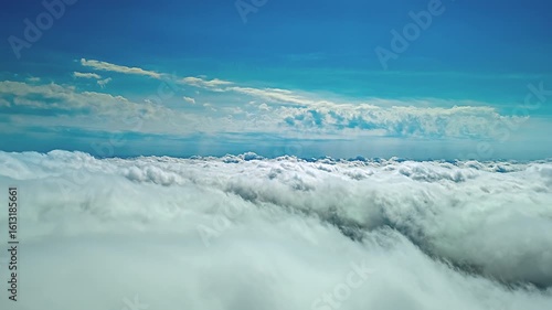 Wallpaper Mural View during a flight over the rolling white cloud cover under a blue sky. Torontodigital.ca
