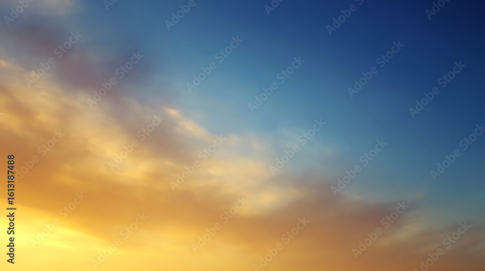 Obraz premium A beautiful gradient sky showcasing a blend of blue, orange, and soft clouds during sunset, perfect for tranquil backgrounds.