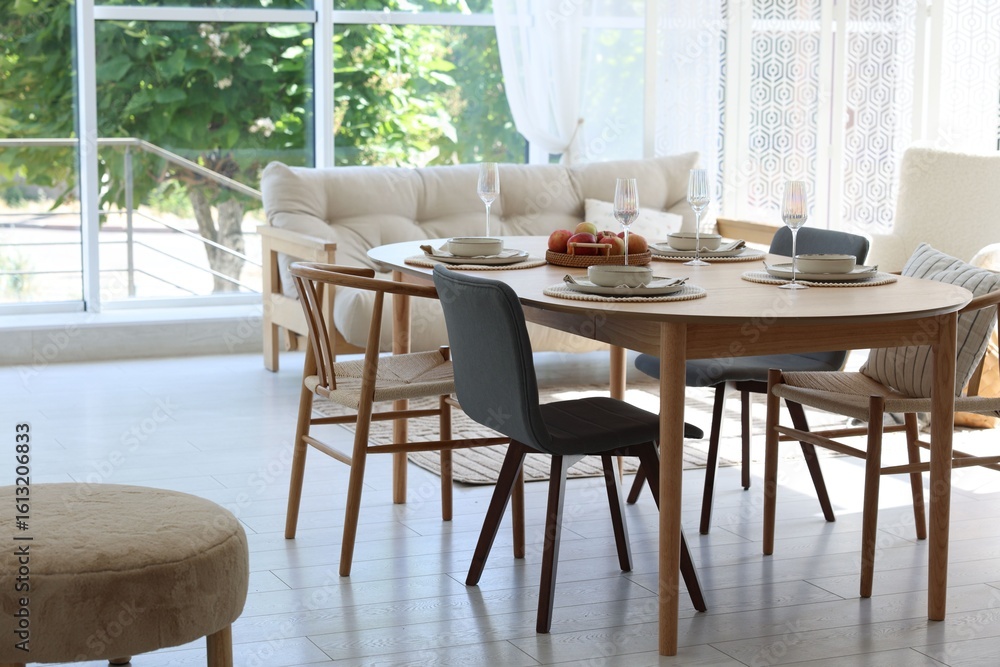 Fototapeta premium Beautiful table setting, chairs and decor in dining room. Interior design