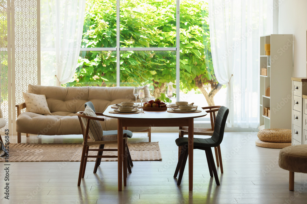 Fototapeta premium Beautiful table setting, chairs and decor in dining room. Interior design