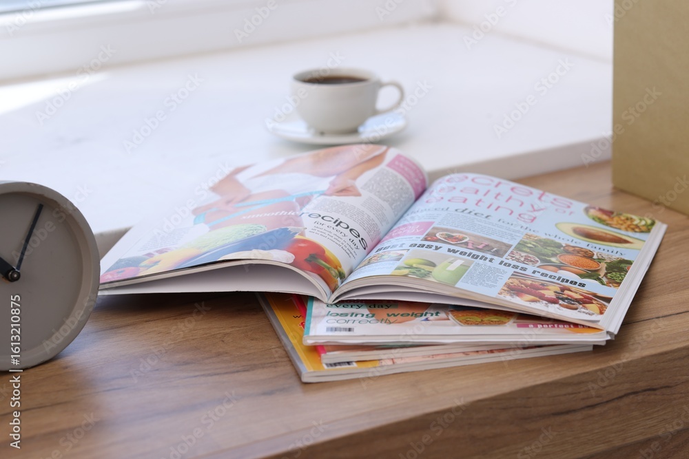 Fototapeta premium Lifestyle magazines on wooden table indoors, closeup