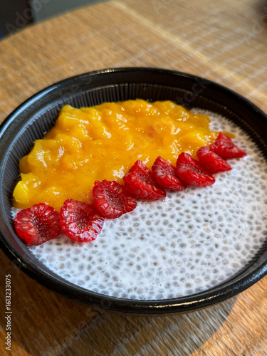 Chia seeds with coconut milk and fresh berries breakfast bowl. UGC cafe picture with healthy meal, close up no people 