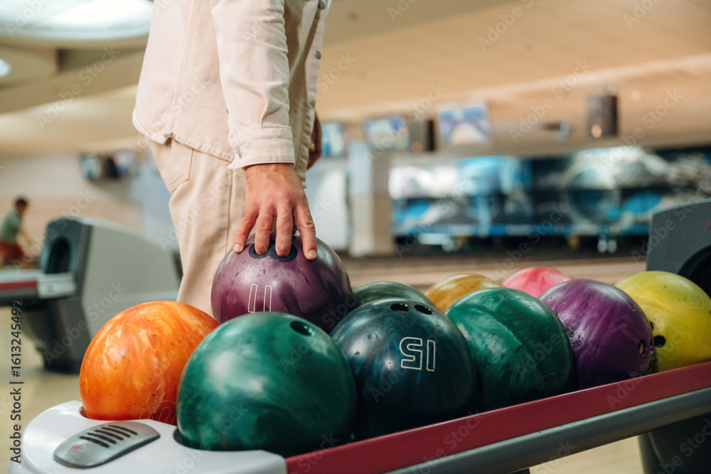 Fototapeta premium Taking the ball. Close up view of man that is playing bowling