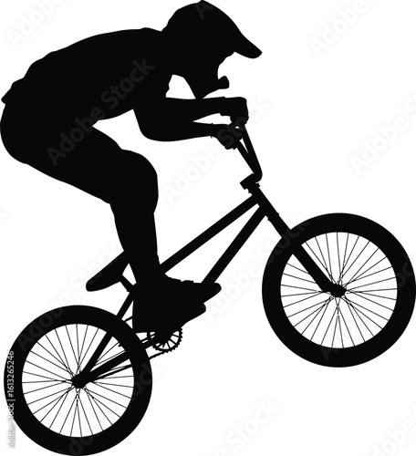 Dynamic bmx rider performing a wheelie trick on a bicycle in a striking black silhouette