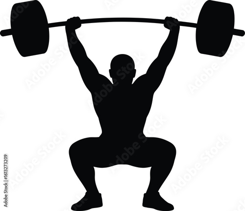 Strong athletic man performing a heavy barbell overhead squat in a powerful silhouette