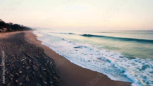Horizontal video waves washing onto sandy beach from sea or ocean