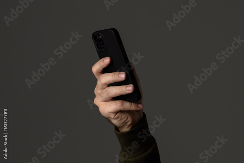 Wallpaper Mural Close-Up View of a Person Holding Smartphone in Hand Torontodigital.ca