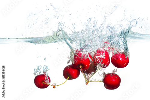 Fresh Sweet Cherries Splashing Into Clear Water With Bubbles
