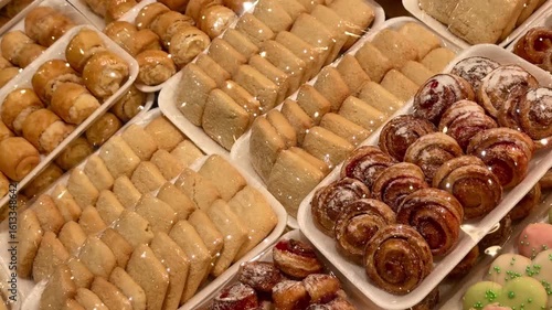 careful packing of biscuits and pastries on disposable plastic substrates in the supermarket. beautiful layout of homemade cookies in the bakery