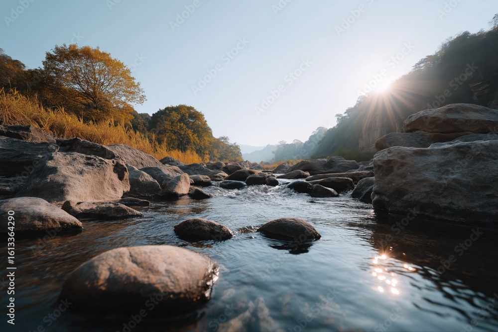 Fototapeta premium Serene river stream with rocky banks at sunrise in tranquil autumn landscape