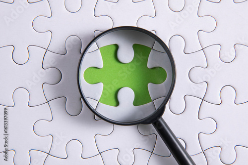 puzzle pieces with a magnifying glass	
