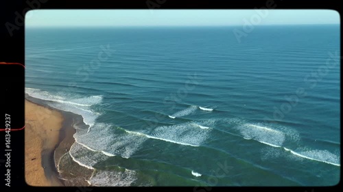Surf waves rolling in at surf spot at dawn in ocean at golden beach, retro grunge film frame 8mm with sprocket, dust and sun leak noise