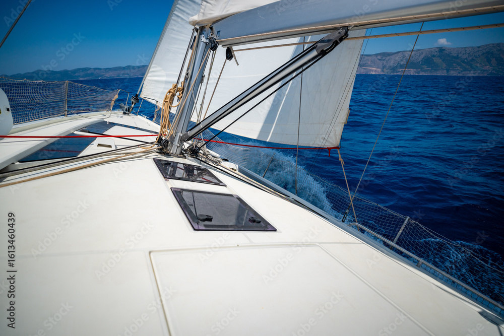 Fototapeta premium Sailing yacht moving at full speed with all sails up in the open sea near Croatia. Dynamic maritime adventure and freedom of ocean travel.