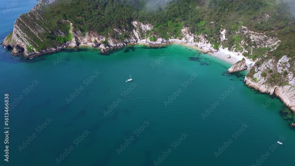 Hidden turquoise cove on Virgin Island Beach with surrounding cliffs and anchored sailboats, Crozon peninsula, Brittany, France. Hidden turquoise cove on Virgin Island Beach with surrounding cliffs and anchored sailboats, Crozon peninsula, Brittany, France.