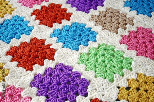 Handmade crocheted blanket using bright and colorful Granny squares