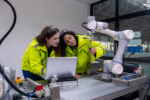 Collaborative robotics training session in a modern laboratory with young engineers at work