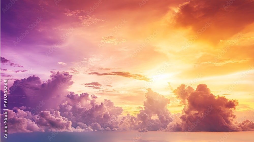 Fototapeta premium Dramatic sunrise with gradient orange and purple clouds, creating a panoramic abstract sky view.