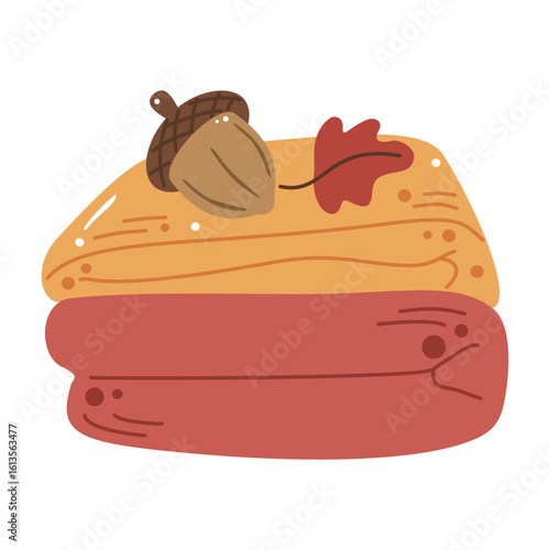 Cozy folded blankets with acorn. Perfect for comfort, home, and seasonal relaxation concepts.