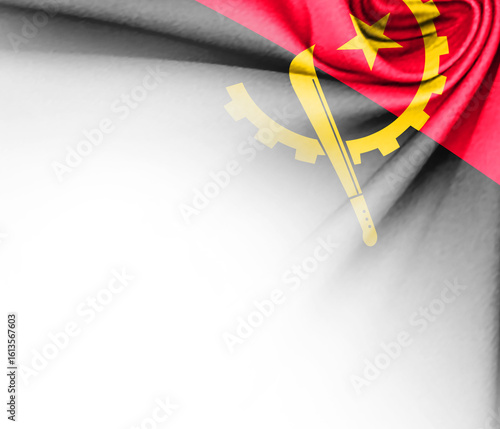 White background with tangled fabric with the flag of Angola