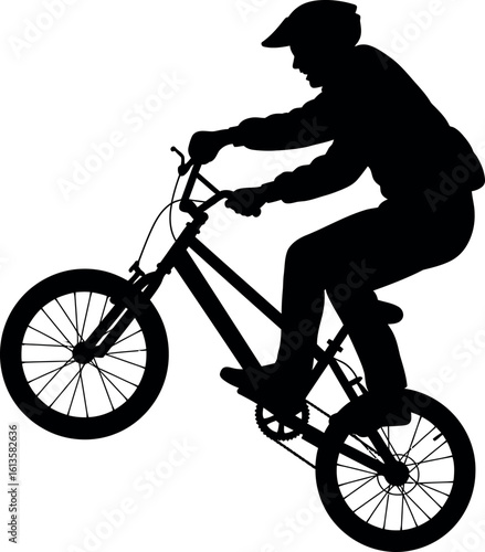 Bmx rider silhouette performing wheelie