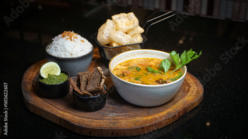 Photos Traditional Indonesian Soto with Dendeng, Rice, and Crackers
