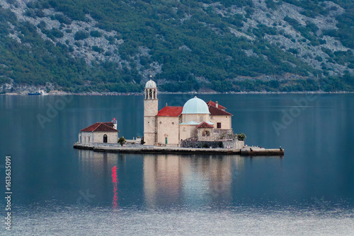 Small island with historic church in the Bay of Kotor, Adriatic Sea, Montenegro. Our Lady of the Rocks is one of the two islets off the coast of Perast near Kotor on the Balkan Peninsula.