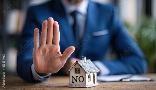 Businessperson rejecting a miniature house